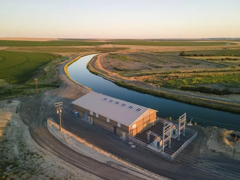 overhead shot of an ECBID waterpump facility next to a canal full of water
